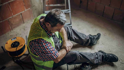 A worker waits for help after suffering from an occupational disease in New Jersey.